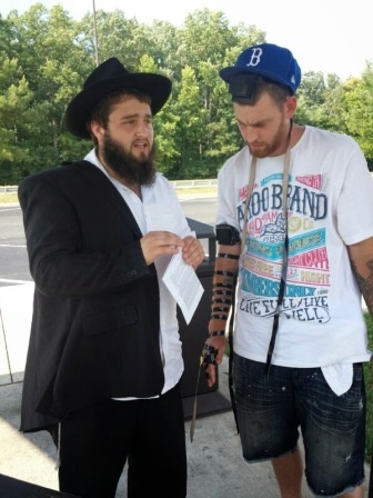 Levi Misholovin puts on Tefillin with a Jew